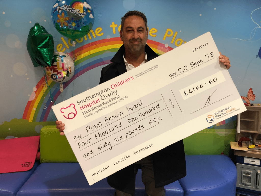 This is a photo of our MD holding a giant cheque for £4166.60 that was raised for the Piam Brown Children's Cancer Ward in Southampton General Hospital.